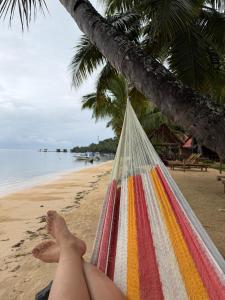 a person laying in a hammock on a beach at le Repaire des Pirates in Sainte Marie