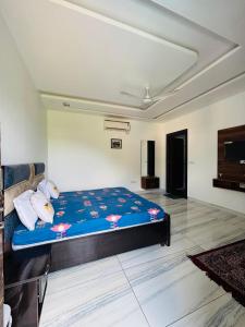 a bedroom with a large bed in a room at Hill Touch Villa in Thūr