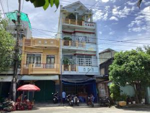 a yellow building with a balcony on top of it at TuNo Homestay in Tuy Hoa