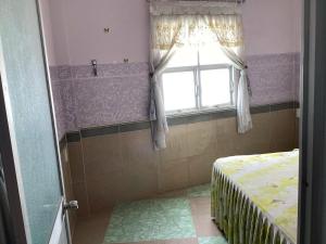 a bedroom with a window and a bed in a room at TuNo Homestay in Tuy Hoa