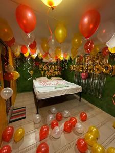 a room with balloons and a table with a cake at Nature Retreat Stay in Pondicherry