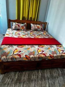 a bedroom with a bed with a colorful comforter at Nature Retreat Stay in Pondicherry +26 photos