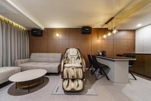 a living room with a couch and a table at Daejeon Brown Dot Wolpyeong in Daejeon