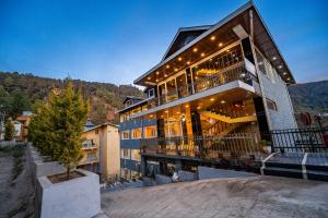 a house with lights on the side of it at Vedikant Pine Tree Resort in Chail