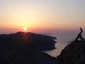 a person standing on top of a mountain at sunset at Anima Apartments in Chora Folegandros
