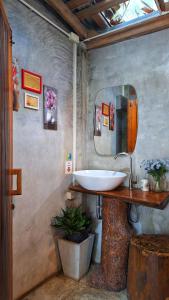 a bathroom with a sink and a mirror at BaanRaiChayKhaoFarmStay in Nakhon Si Thammarat