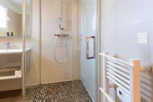 a shower with a glass door in a bathroom at Hôtel CASABELLA Cannes Mouans Sartoux in Mouans-Sartoux +67 photos