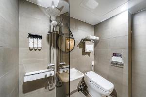 a small bathroom with a toilet and a shower at Daejeon Brown Dot Wolpyeong in Daejeon +90 photos
