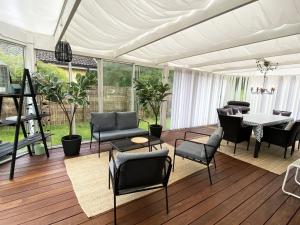 a living room with a table and chairs at Charming villa near the beach in Vejbystrand SE01066 in Vejbystrand