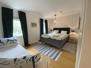 a bedroom with two beds and a window at Charming villa near the beach in Vejbystrand SE01066 in Vejbystrand +48 photos