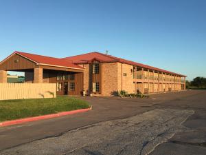 a large brick building with a road in front of it at Chaparral Motel in Port Lavaca