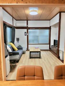 a living room with a couch and a table at はつはな in Osaka
