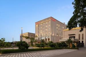 a large building with a lot of windows at Ramada by Wyndham Sonipat Murthal in Sonīpat