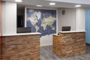 a lobby with a map of the world on the wall at Days Inn by Wyndham Waukegan Great Lakes-Free Breakfast and Naval Base Shuttle in Waukegan