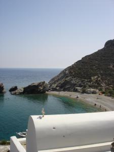 a view of a beach with people in the water at Anima Apartments in Chora Folegandros
