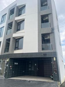 a tall white building with a lot of windows at 5920 Elevator Guesthouse-5920電梯民宿 立案編號3020 in Wujie