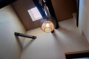 an overhead view of a light hanging from a ceiling at 瓦町家kawaramachiya in Takamatsu