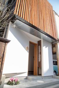a small building with a door in front at 瓦町家kawaramachiya in Takamatsu