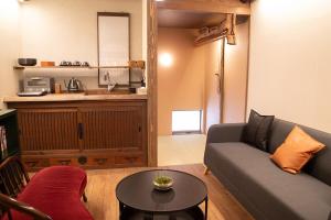a living room with a couch and a table at 瓦町家kawaramachiya in Takamatsu +22 photos