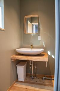 a bathroom with a sink and a mirror at 瓦町家kawaramachiya in Takamatsu