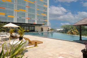 a swimming pool in front of a building at Ascent Premiere Hotel and Convention in Malang