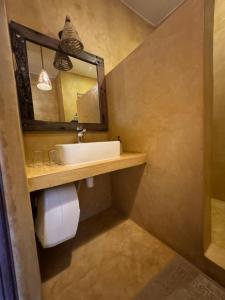 a bathroom with a sink and a mirror at Tangawizi Lodge Zanzibar - Adults Only in Jambiani +167 photos