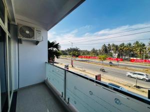 a balcony with a window view of a street at Surabhi Comforts Inn in Mysore