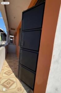a black dresser sitting next to a wall at ADONAI homes in Malindi