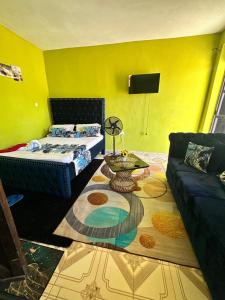 a living room with a bed and a couch at ADONAI homes in Malindi