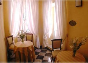a dining room with two tables and a window at Camere D'Autore La Poesia in Monterosso al Mare