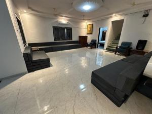 a large living room with a couch and chairs at Classy Stay Villa - Karjat in Dhamni