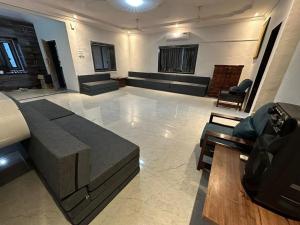 a large living room with a couch and a table at Classy Stay Villa - Karjat in Dhamni +14 photos