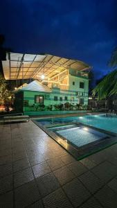 a building with a swimming pool in front of a building at Classy Stay Villa - Karjat in Dhamni