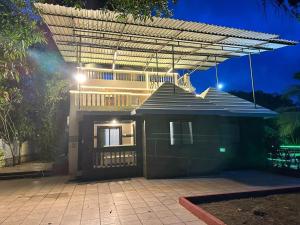 a house with awning on top of it at night at Classy Stay Villa - Karjat in Dhamni