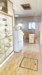 an empty room with a refrigerator and a wooden floor at 富士見旅館101 in Fujiyoshida