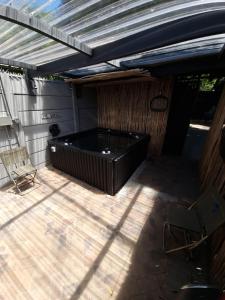 a large black tub sitting on a patio at Rose’s Place in Durbanville