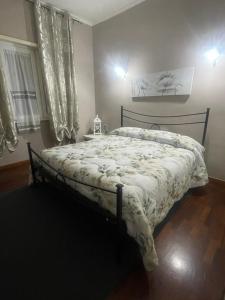 a bedroom with a bed with a white comforter at Casa Luna in Pomezia