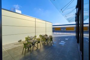 a group of tables and chairs on a balcony at Kongres Hotel Roca in Košice