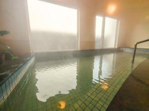 a swimming pool with water in a room at Hotel Sol at Lake Toya in Lake Toya