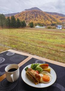 a plate of food on a table with a cup of coffee at Hotel Sol at Lake Toya in Lake Toya