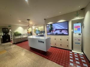 a hospital room with a television and a bed at Fritta Hotel in Suwon +12 photos
