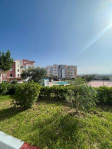 a view of a park with trees and buildings at ADORA Apartment in Tangier