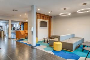 a waiting room with a couch and chairs at Microtel Inn & Suites by Wyndham Montgomery in Mitylene
