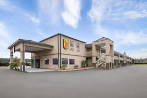 a large building with a fast food restaurant at Super 8 by Wyndham Macon West in Macon
