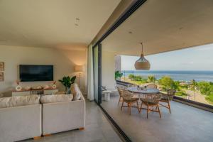 a living room with a couch and a table and chairs at The View Mauritius in Ruisseau Créole