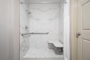 a white bathroom with a toilet and a sink at Super 8 by Wyndham Macon West in Macon +24 photos
