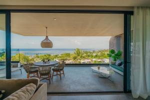 an open living room with a view of the ocean at The View Mauritius in Ruisseau Créole