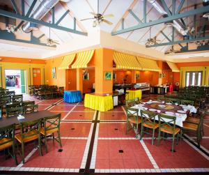 an empty dining room with tables and chairs at Brookside Valley Resort in Rayong