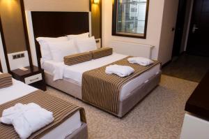 Postel nebo postele na pokoji v ubytování Lavin Hotel & Spa