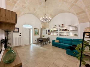 a living room with a blue couch and a table at Dimora Imperiali in Francavilla Fontana